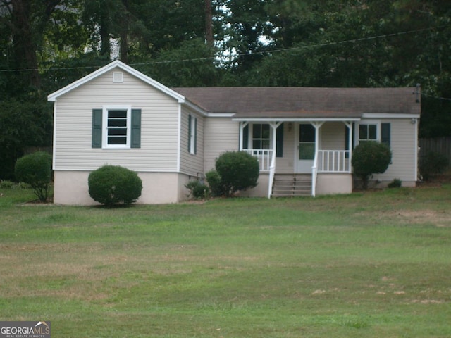 ranch-style house with a front lawn and covered porch