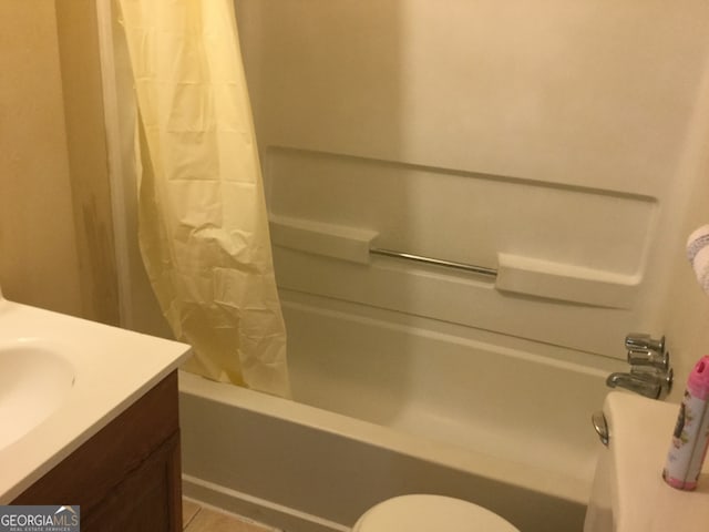 full bathroom featuring toilet, sink, and shower / bath combo with shower curtain