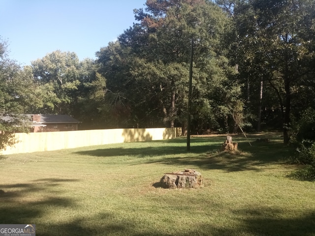 view of yard with a fire pit