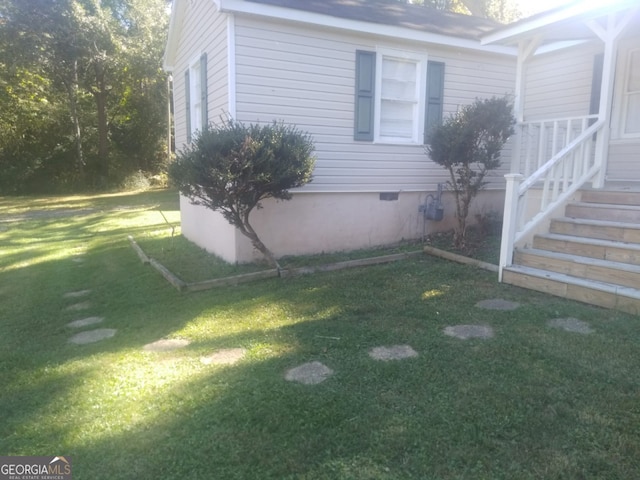 view of home's exterior with a yard