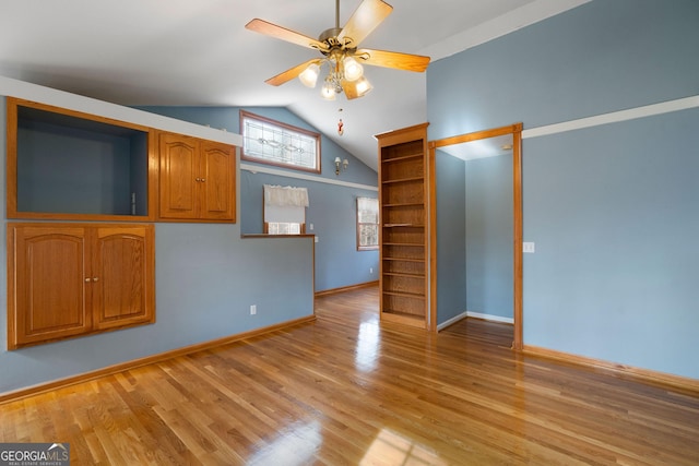 unfurnished living room with lofted ceiling, ceiling fan, and light hardwood / wood-style flooring