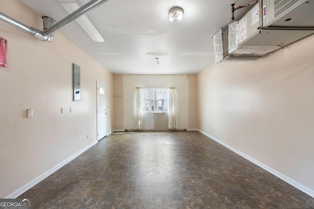 unfurnished room featuring electric panel