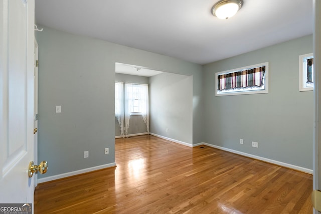 empty room with hardwood / wood-style floors