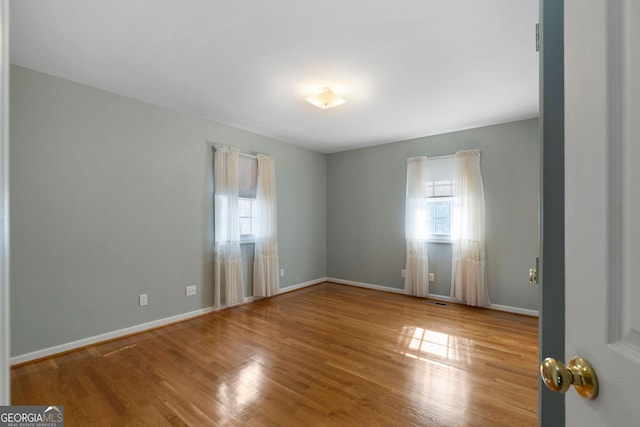 unfurnished room featuring wood-type flooring