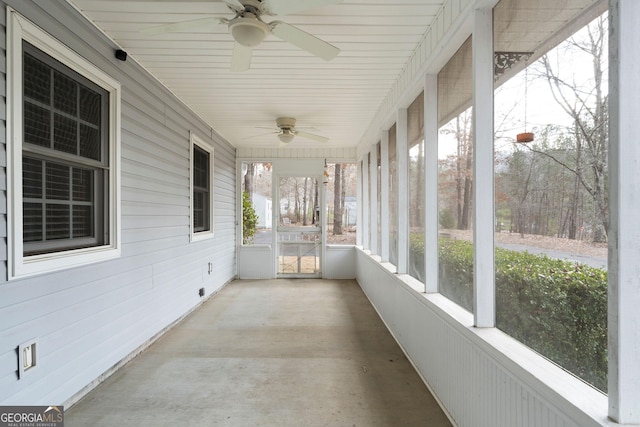 unfurnished sunroom with ceiling fan