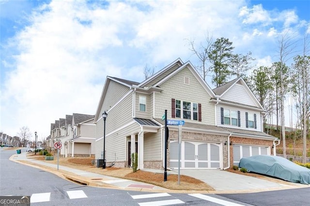 view of front of house featuring a garage and central air condition unit