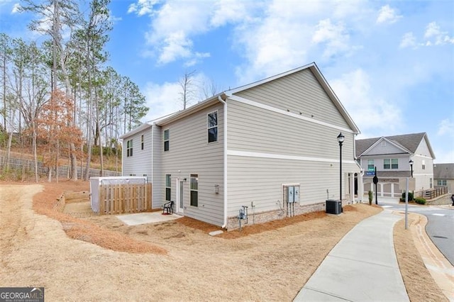 view of side of home with a jacuzzi and central AC