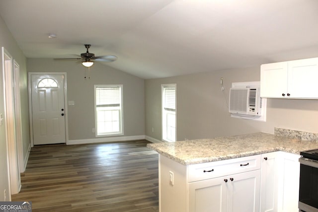 kitchen with an AC wall unit, white cabinetry, lofted ceiling, ceiling fan, and dark wood-type flooring