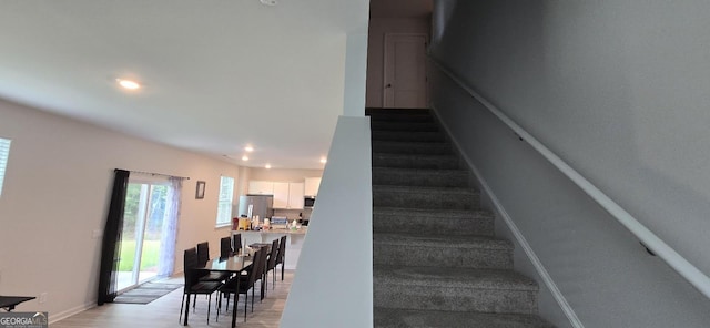 staircase with hardwood / wood-style flooring