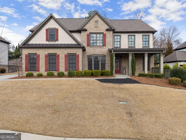 6514 Lemon Grass Ln, Flowery Branch, GA 30542 - view of front facade featuring covered porch, brick siding, and a shingled roof