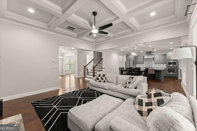 living room featuring beamed ceiling, coffered ceiling, and dark wood-type flooring