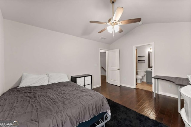 bedroom featuring vaulted ceiling, dark wood-type flooring, ensuite bathroom, and ceiling fan