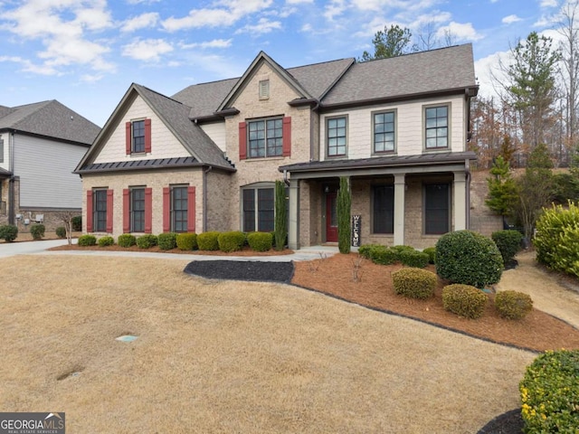 6514 Lemon Grass Ln, Flowery Branch, GA 30542 - view of front of house with a porch, a shingled roof, brick siding, and a standing seam roof
