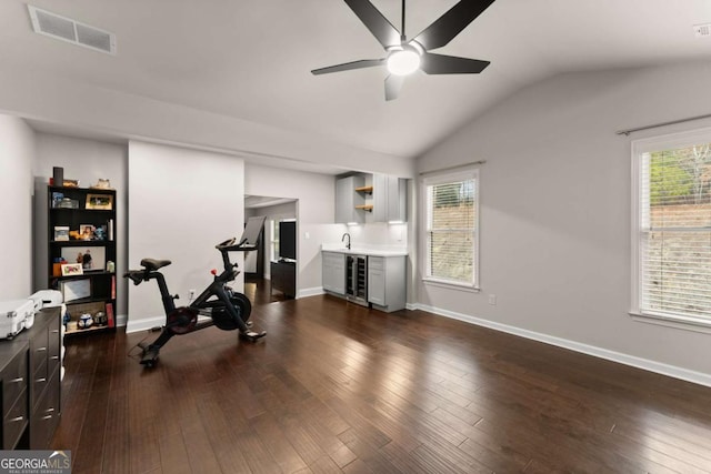 exercise area featuring lofted ceiling, sink, ceiling fan, wine cooler, and dark hardwood / wood-style flooring