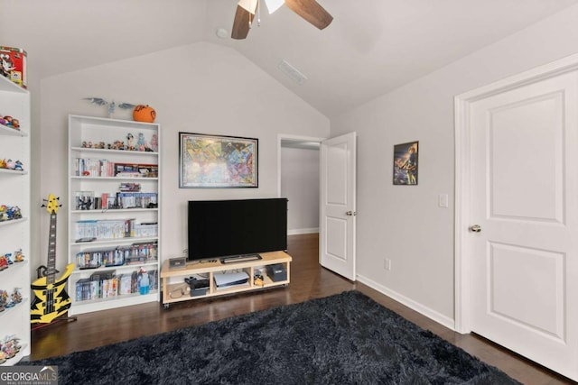 living room featuring built in shelves, ceiling fan, dark hardwood / wood-style floors, and vaulted ceiling