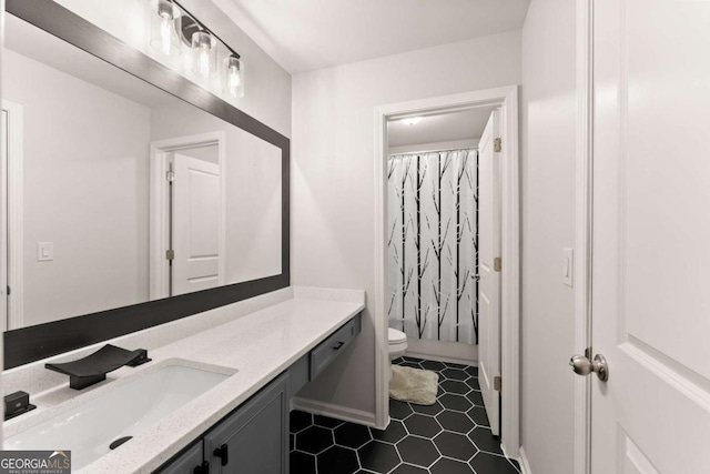 bathroom with vanity, curtained shower, tile patterned floors, and toilet