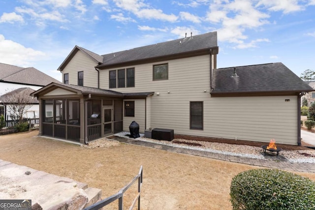 6514 Lemon Grass Ln, Flowery Branch, GA 30542 - back of house with a sunroom, a fire pit, and roof with shingles