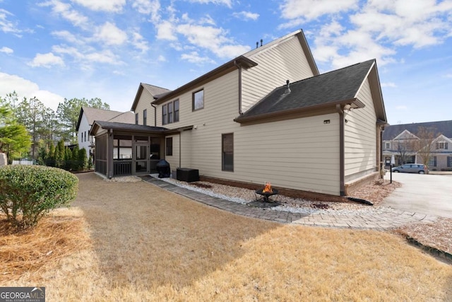 back of property with a sunroom