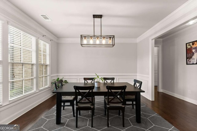 dining room with dark wood-type flooring and ornamental molding