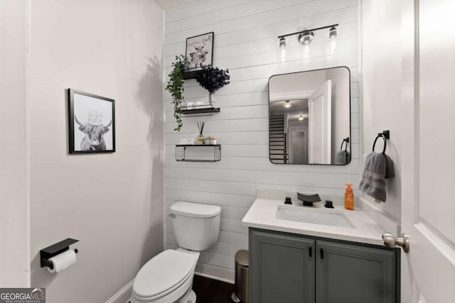 bathroom with vanity, hardwood / wood-style floors, and toilet