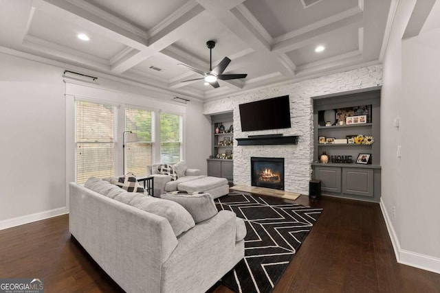 6514 Lemon Grass Ln, Flowery Branch, GA 30542 - living room featuring dark wood-type flooring, ceiling fan, a stone fireplace, beam ceiling, and coffered ceiling