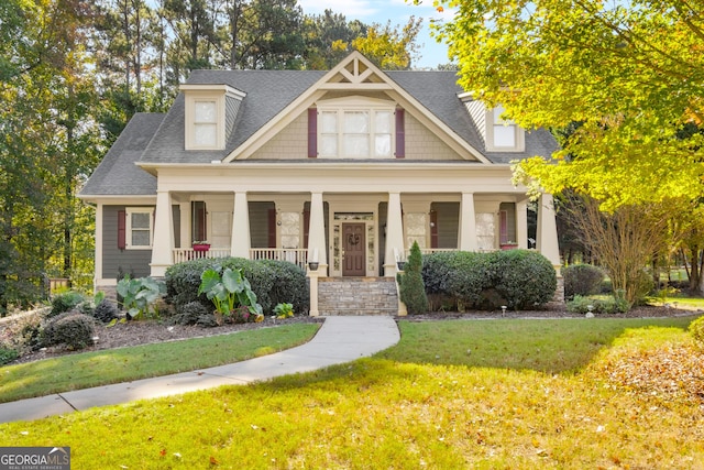 craftsman house with covered porch and a front lawn