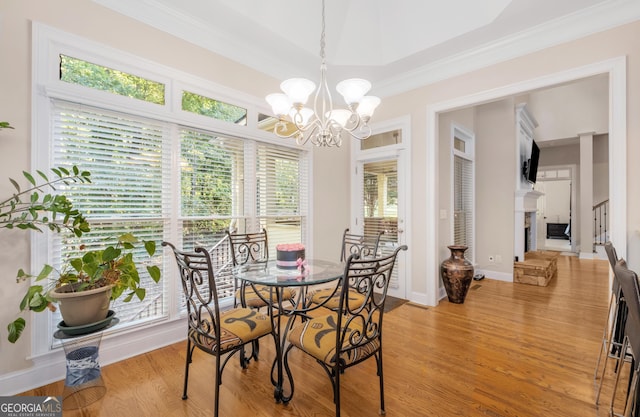 kitchen featuring brown cabinetry, appliances with stainless steel finishes, a peninsula, and crown molding