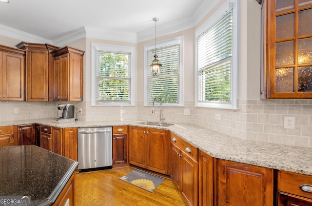 kitchen featuring stainless steel dishwasher, a sink, and light wood finished floors