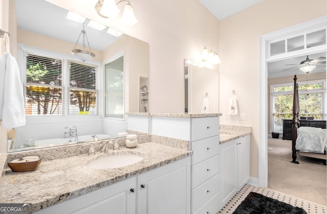 full bath with vanity, a freestanding tub, tile patterned floors, and wainscoting