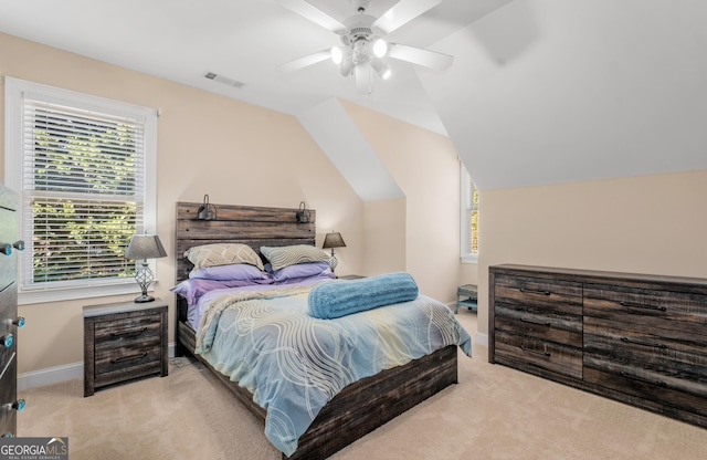 bedroom with a ceiling fan, light colored carpet, and vaulted ceiling