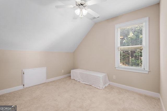 interior space featuring baseboards, carpet, lofted ceiling, and visible vents