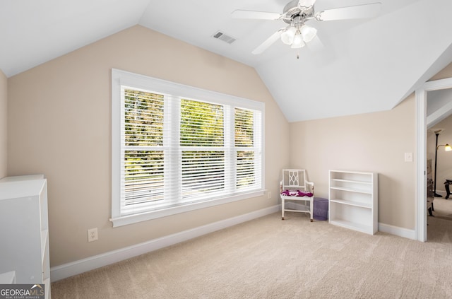 home office featuring ceiling fan, light colored carpet, built in study area, lofted ceiling, and visible vents