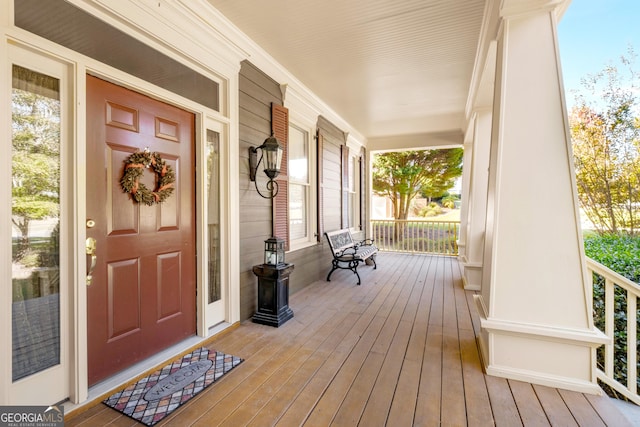 entrance foyer featuring crown molding, baseboards, and light wood-style flooring