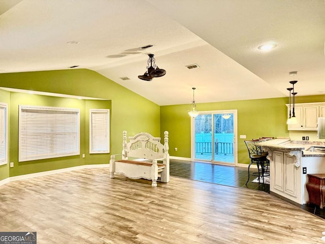 sitting room featuring vaulted ceiling and light hardwood / wood-style floors