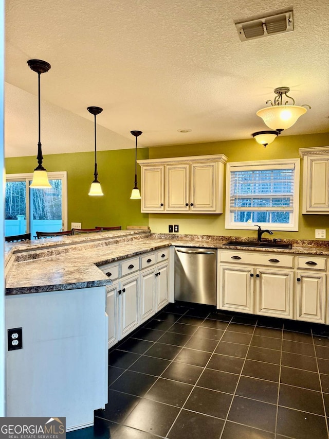 kitchen with pendant lighting, sink, white cabinets, stainless steel dishwasher, and kitchen peninsula