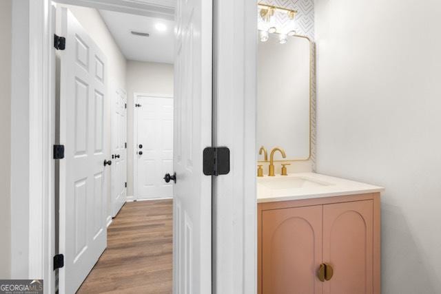 bathroom with vanity and hardwood / wood-style floors