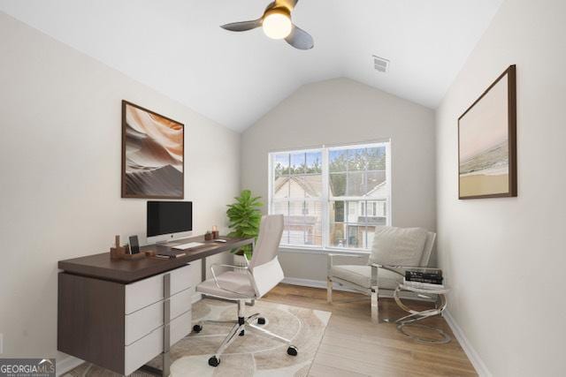 office space with ceiling fan, vaulted ceiling, and light hardwood / wood-style flooring