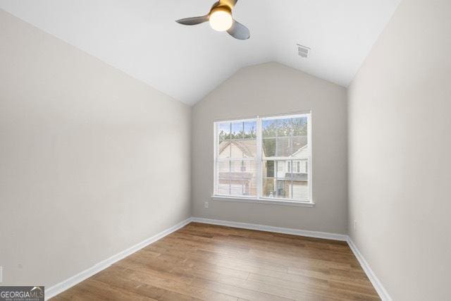 unfurnished room featuring lofted ceiling, wood-type flooring, and ceiling fan