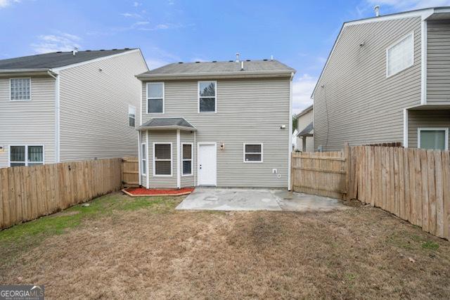 back of property featuring a yard and a patio