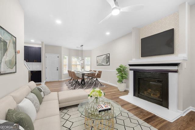 living room with hardwood / wood-style flooring and ceiling fan