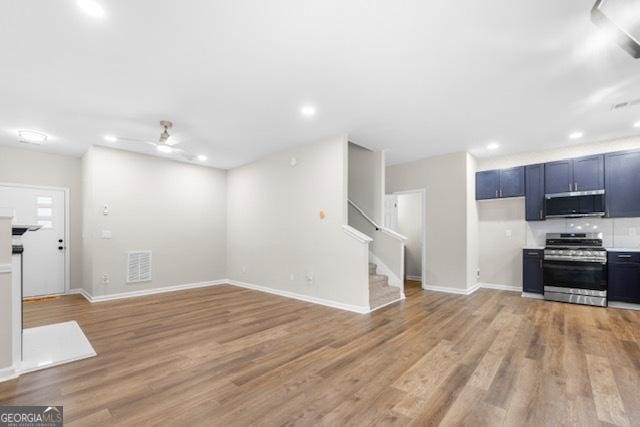 unfurnished living room with ceiling fan and light hardwood / wood-style floors