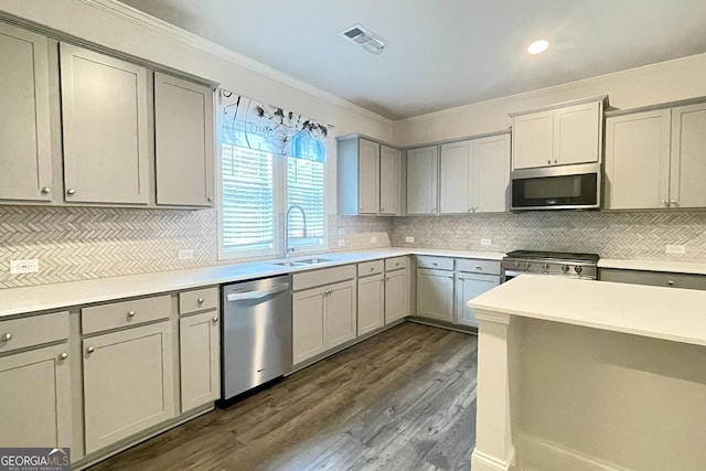 kitchen with gray cabinets, ornamental molding, appliances with stainless steel finishes, and sink