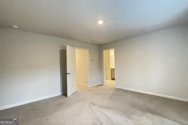 unfurnished room with light colored carpet