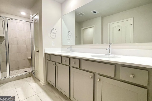 bathroom with walk in shower, vanity, and tile patterned flooring