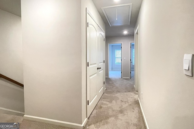 hallway with light colored carpet