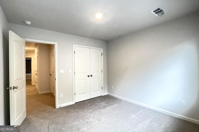 unfurnished bedroom featuring carpet flooring and a closet