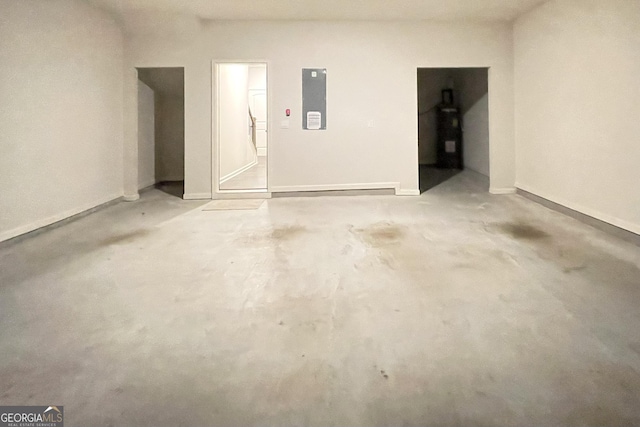 garage with electric panel and water heater