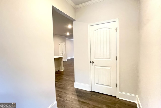 hall with ornamental molding and dark hardwood / wood-style flooring