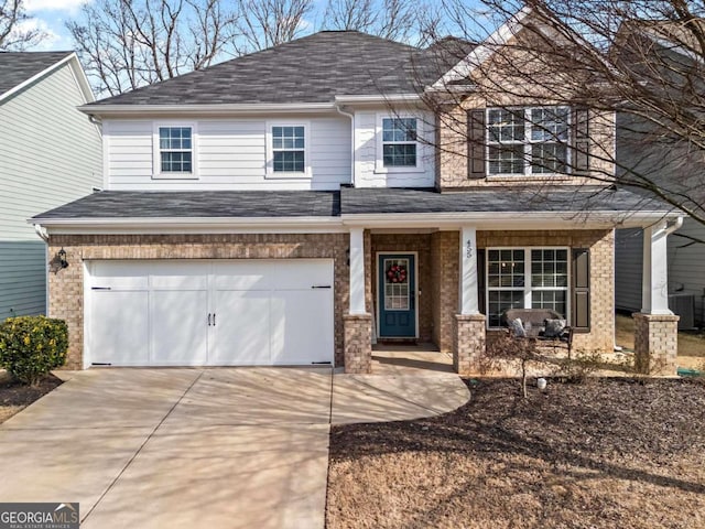 view of front of property with a garage, a porch, and central AC