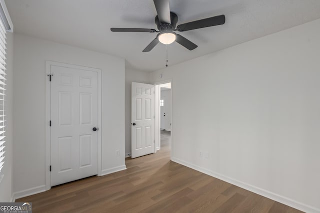 unfurnished bedroom featuring hardwood / wood-style flooring and ceiling fan